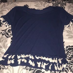 blue shirt with white tassels